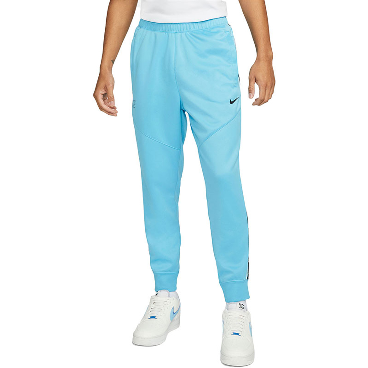Nike repeat print track pants shop